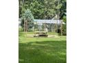 Backyard with picnic table and string lights at 7253 Hunt Valley Trl, Wendell, NC 27591