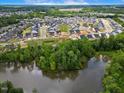 Aerial view of a lakefront community with numerous houses at 3102 Castlerock Dr # 2, Burlington, NC 27215