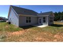 Gray siding home with small patio and grassy backyard at 3102 Castlerock Dr # 2, Burlington, NC 27215