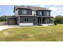 Two-story home with gray exterior, white trim, two-car garage, and green lawn at 6920 Will Let Ln, Wake Forest, NC 27587