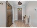 Inviting entryway with a rustic barn door and hardwood floors at 6920 Will Let Ln, Wake Forest, NC 27587