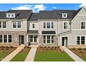 Two story townhouses with gray siding and stone accents at 1431 Goldsboro Ave, Sanford, NC 27330