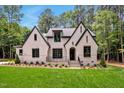 Stunning two-story house with white brick and black windows at 503 Damascus Church Rd, Chapel Hill, NC 27516