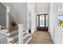 Bright entryway with hardwood floors and modern staircase at 4566 Ashtons Way, Franklinton, NC 27525