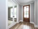 Light and airy entryway with mirrored doors and hardwood floors at 1000 Azalea Garden Circle, Raleigh, NC 27603