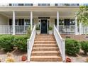 Front porch with brick stairs and columns at 1329 Endgame Ct, Wake Forest, NC 27587