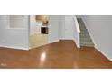 Open concept living space with hardwood floors and kitchen views at 320 Gilman Ln # 110, Raleigh, NC 27610