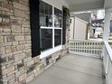 Covered porch with stone facade and white railing at 2318 Kingscup Ct # 224, Apex, NC 27502