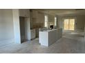 Open kitchen with island and white cabinets at 106 Wichita Way, Louisburg, NC 27549