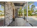Covered porch with stone flooring and exterior lighting at 111 November Dr, Durham, NC 27712