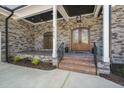 Stone porch with double doors and a covered entry at 111 November Dr, Durham, NC 27712