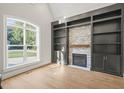 Spacious living room with a stone fireplace and built-in shelving at 109 November Dr, Durham, NC 27712