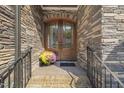 Double wood door entry with stone facade and flowers at 109 November Dr, Durham, NC 27712