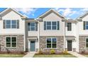 Three-unit townhouse building with stone accents at 863 Old Tarboro Rd, Wendell, NC 27591