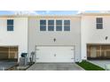 Rear view of townhome showing a double garage and additional storage at 863 Old Tarboro Rd, Wendell, NC 27591