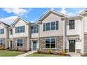 Two story townhome with stone accents and a teal door at 859 Old Tarboro Rd, Wendell, NC 27591