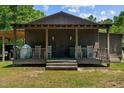 Dark brown exterior with a covered porch and rocking chairs at 113 Amelia Ln, Holly Springs, NC 27540