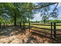 Wooden fence encloses a grassy field, creating a tranquil pastoral setting at 113 Amelia Ln, Holly Springs, NC 27540