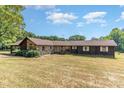 Ranch style home with stone and wood siding at 8450 Perry Rd, Graham, NC 27253