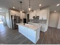 Modern kitchen with white cabinets, quartz countertops, and stainless steel appliances at 6980 Doddridge Ln # 5, Cary, NC 27519