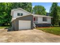Ranch home with gray and white exterior, red door and attached garage at 1844 Brier Ln, Graham, NC 27253