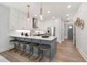 Island kitchen with gray cabinets, white quartz countertops, and gold accents at 4035 Elk Creek Ln # 18, Raleigh, NC 27612