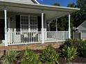 Front porch with white railing and landscaping at 970 Southern High School Rd, Graham, NC 27253