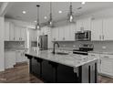 Modern kitchen with large island, stainless steel appliances, and granite countertops at 91 Walker Grove Ln, Lillington, NC 27546