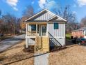Gray sided craftsman style home with wooden stairs and front porch at 531 Booth St, Roxboro, NC 27573