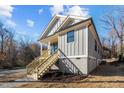 Gray sided craftsman style home with wooden stairs and side yard at 531 Booth St, Roxboro, NC 27573