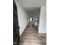 Bright entryway with dark door and view into living area at 32 Scotties Ridge Dr, Princeton, NC 27569