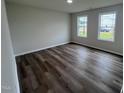 Bright bedroom with two windows and wood-look flooring at 72 Scotties Ridge Dr, Princeton, NC 27569