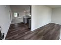 View from entryway into living room and kitchen area with gray cabinets at 72 Scotties Ridge Dr, Princeton, NC 27569