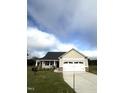 Tan house with a two car garage and landscaping at 158 Scotties Ridge Dr, Princeton, NC 27569