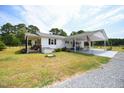 White ranch home with a carport and large backyard at 101 Mulberry Ln, Dunn, NC 28334