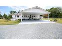 House exterior showcasing a carport and gravel driveway at 101 Mulberry Ln, Dunn, NC 28334