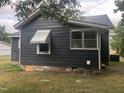 Gray house exterior with a green awning and brick base at 3124 Raleigh Rd, Henderson, NC 27537