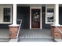 Gray house with red front door and a porch at 3124 Raleigh Rd, Henderson, NC 27537