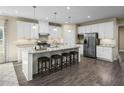 Modern kitchen featuring white cabinets, granite countertops, and stainless steel appliances at 508 Impala Trce, Wendell, NC 27591