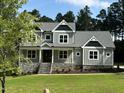 Two-story home with gray siding and stone accents at 200 Whistlers Cv, Louisburg, NC 27549