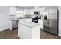 Modern kitchen with white cabinets and stainless steel appliances at 4511 Black Drum Dr, Raleigh, NC 27616