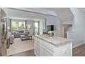 Open kitchen with island and view into living room at 4511 Black Drum Dr, Raleigh, NC 27616
