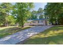 Ranch style home with a long driveway and mature trees at 2405 Rock Quarry Rd, Raleigh, NC 27610