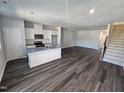 Modern kitchen with island and hardwood floors at 567 Marthas Vw Way, Wake Forest, NC 27587