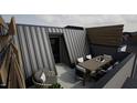 Modern rooftop deck with wooden furniture, offering a relaxing outdoor space at 512 Gordon St # 407, Durham, NC 27701