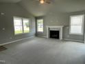 Living room with a cozy fireplace and plenty of natural light at 86 Scotties Ridge Dr, Princeton, NC 27569
