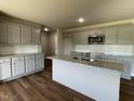 Modern kitchen with gray cabinets, granite countertops, and an island at 114 Scotties Ridge Dr, Princeton, NC 27569