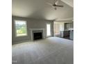 Spacious living room with fireplace, vaulted ceiling, and carpeted floor at 114 Scotties Ridge Dr, Princeton, NC 27569