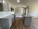 Open kitchen features granite countertops and island overlooking living room at 114 Scotties Ridge Dr, Princeton, NC 27569