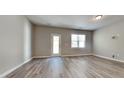 Spacious living room with vinyl plank flooring and door access to backyard at 3635 Water Mist Ln, Raleigh, NC 27604